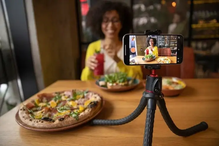 Video shoot of woman with food at a restaurant for social media