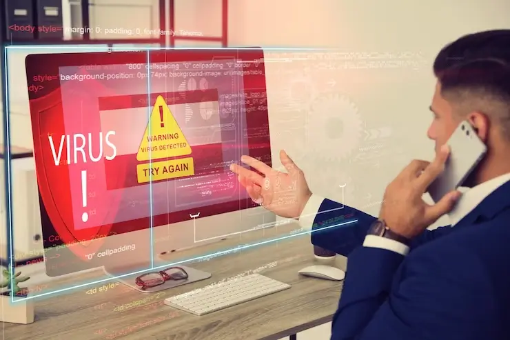 Office worker front computer with warning about virus attack